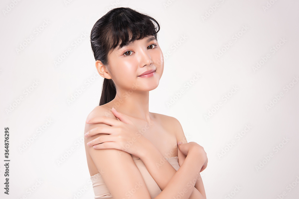Obraz premium Beautiful Young Asian Woman touching her body with fresh Healthy Skin, isolated on white background, Beauty Cosmetics and Facial treatment Concept.