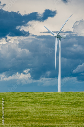 Storm clouds over wind turbines in a wheat field outside Swift Current, Saskatchewan, Canada