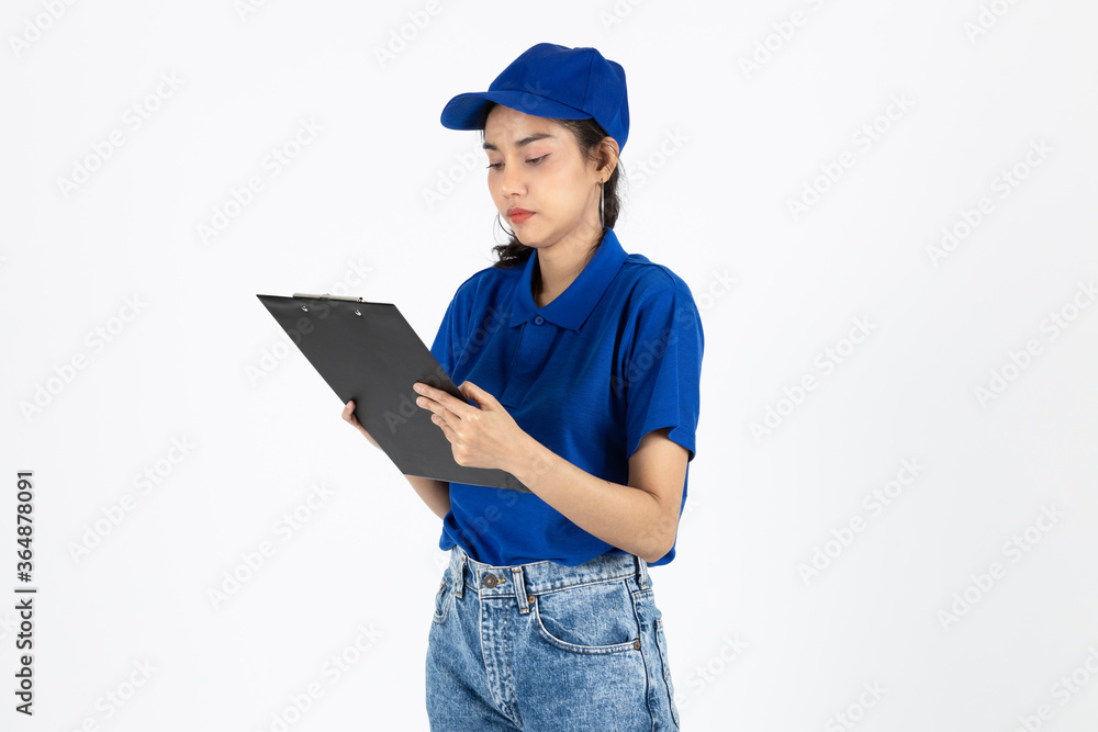 Young delivery Asian woman in blue uniform holding clipboard over white isolated background. Young delivery Asian woman in blue uniform holding clipboard over white isolated background.