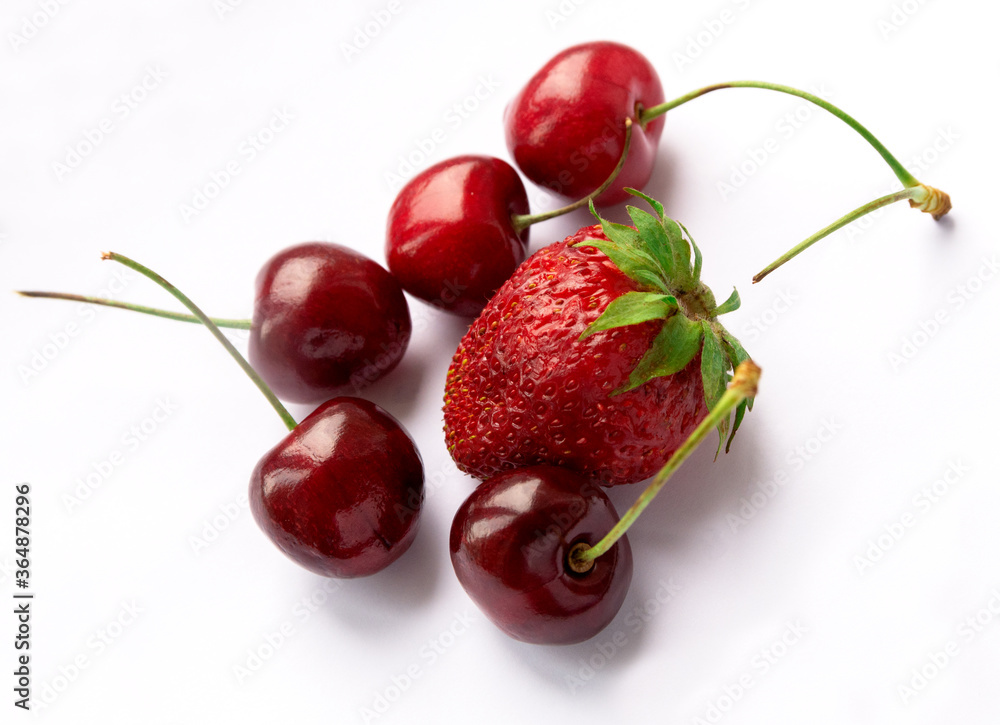 Fresh ripe berries photographed on a white background. Isolated. Strawberries and cherries. Fresh ripe berries photographed on a white background. Isolated. Strawberries and cherries.