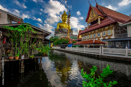 Background of a large Buddha statue in Bangkok(Wat Pak Nam Phasi Charoen),over 69 meters in height, stands majestically in the capital,a historical and cultural attraction that tourists come to see