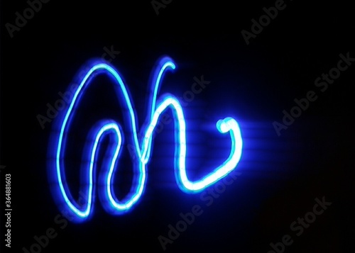 Light painting design. Combination of sky blue and white light against a black background 