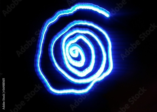 Light painting design. Combination of sky blue and white light against a black background 