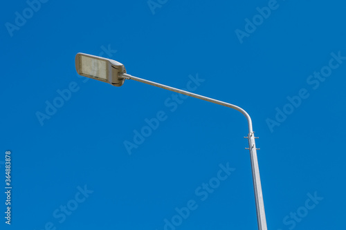 Street lamp against a clear blue sky. .A modern street LED lighting pole. Copy space.