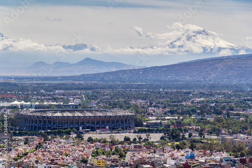 aerial view of azteca stadium and iconic snowed volcanoes in the back