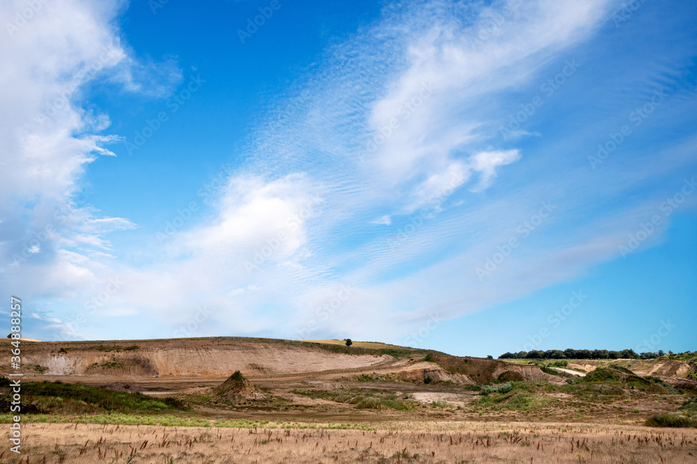 Gravel pit in a rural landscape with dry flora