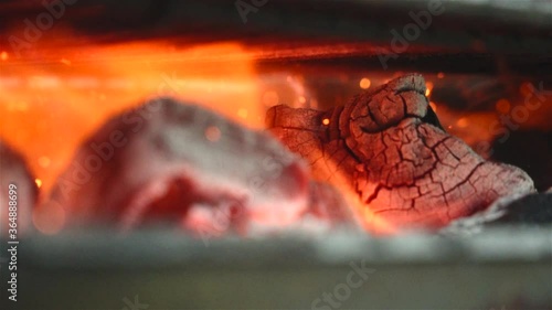 close up of charcoal burning in a grill in slow motion