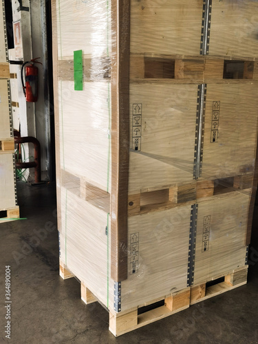 Shipment cartons box on pallets and wooden case on forklift in interior warehouse cargo for export and sorting goods in freight logistics and transportation industrial