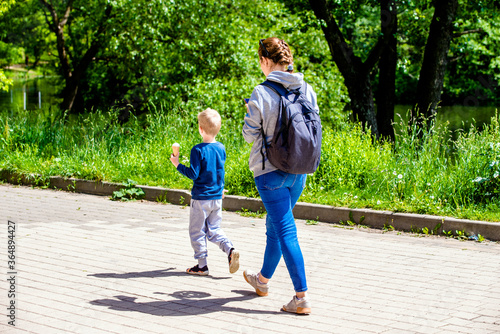 Mother and son walking in the summer Park
