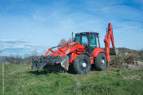 Tractor with backhoe in action