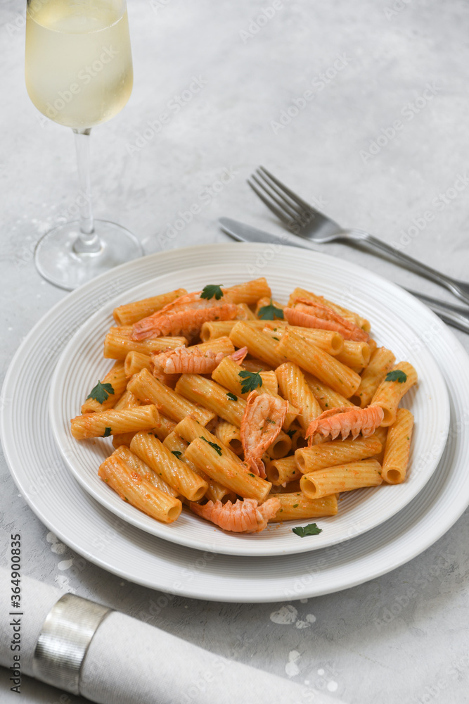 Penne pasta or Italian rigatoni with langoustines and tomato sauce in white plate top view. seafood pasta recipe Penne pasta or Italian rigatoni with langoustines and tomato sauce in white plate top view. seafood pasta recipe