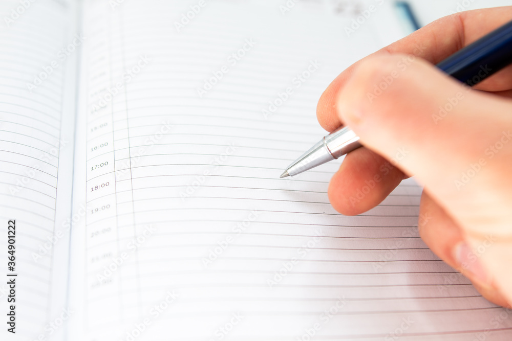 pen in hand and a sheet of paper pen in hand and a sheet of paper