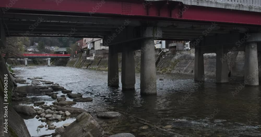 Walking under the bridge, small mountain river in the city. Traditional historic Japanese houses at the riverside . Steady POV walking, Takayama, Japan. Walking under the bridge, small mountain river in the city. Traditional historic Japanese houses at the riverside . Steady POV walking, Takayama, Japan.