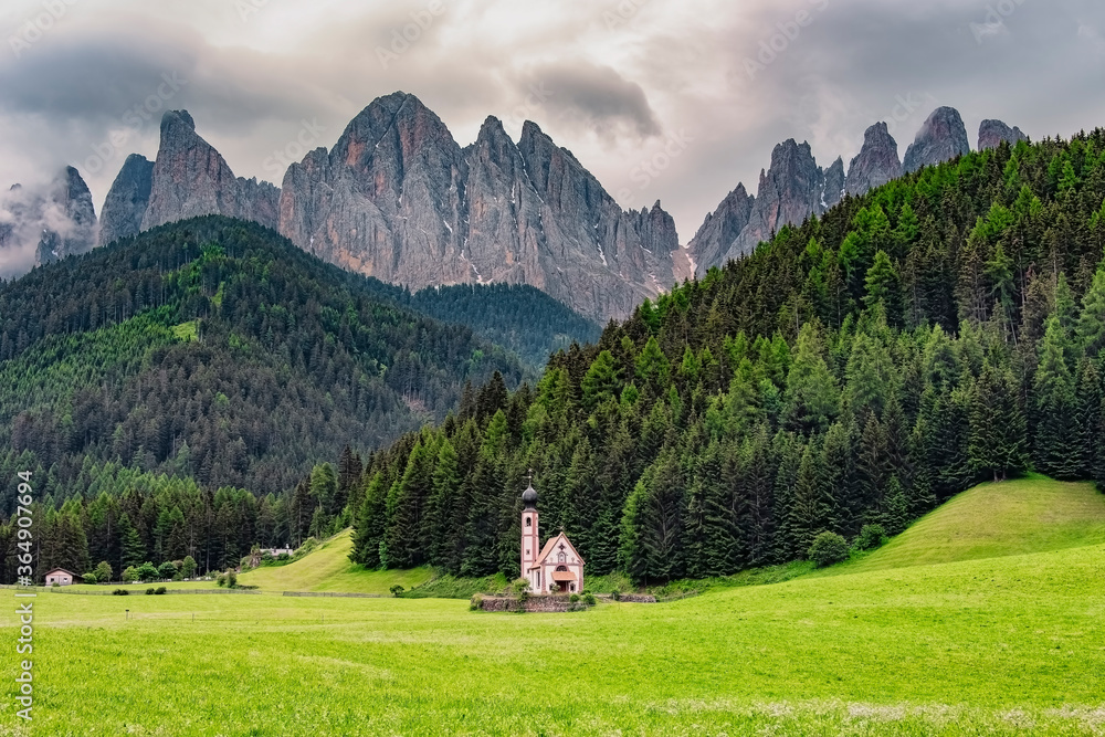 The scenery of the Dolomites with the St. John's in Ranui Chapel in Santa Maddalena. Italy