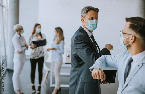 Two colleagues avoid a hand...
