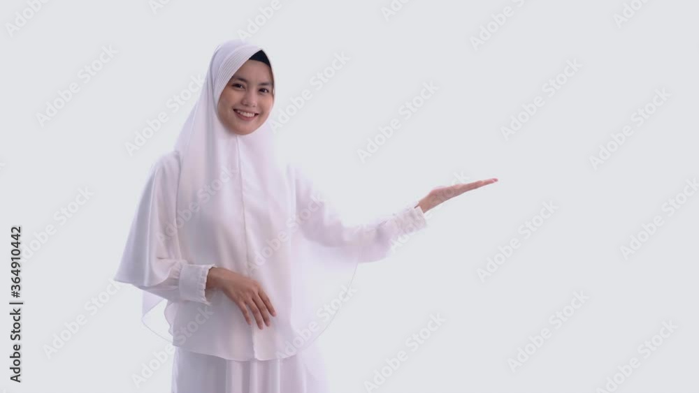 muslim beautiful asian woman with white hijab presenting smiling to camera muslim beautiful asian woman with white hijab presenting smiling to camera