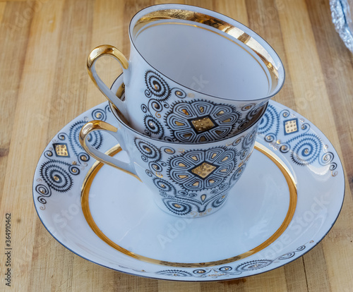 striking Chinese porcelain Cup with saucer on a wooden background