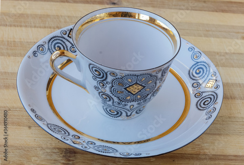 striking Chinese porcelain Cup with saucer on a wooden background