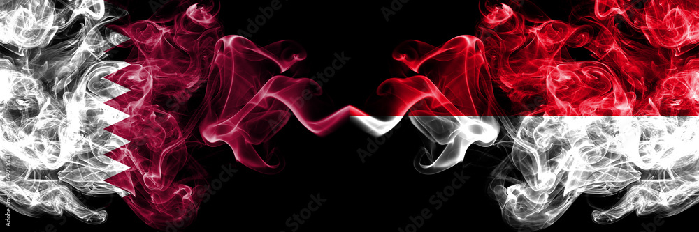 Fototapeta premium Qatar vs Monaco, Monacan smoky mystic flags placed side by side. Thick colored silky abstract smoke flags.