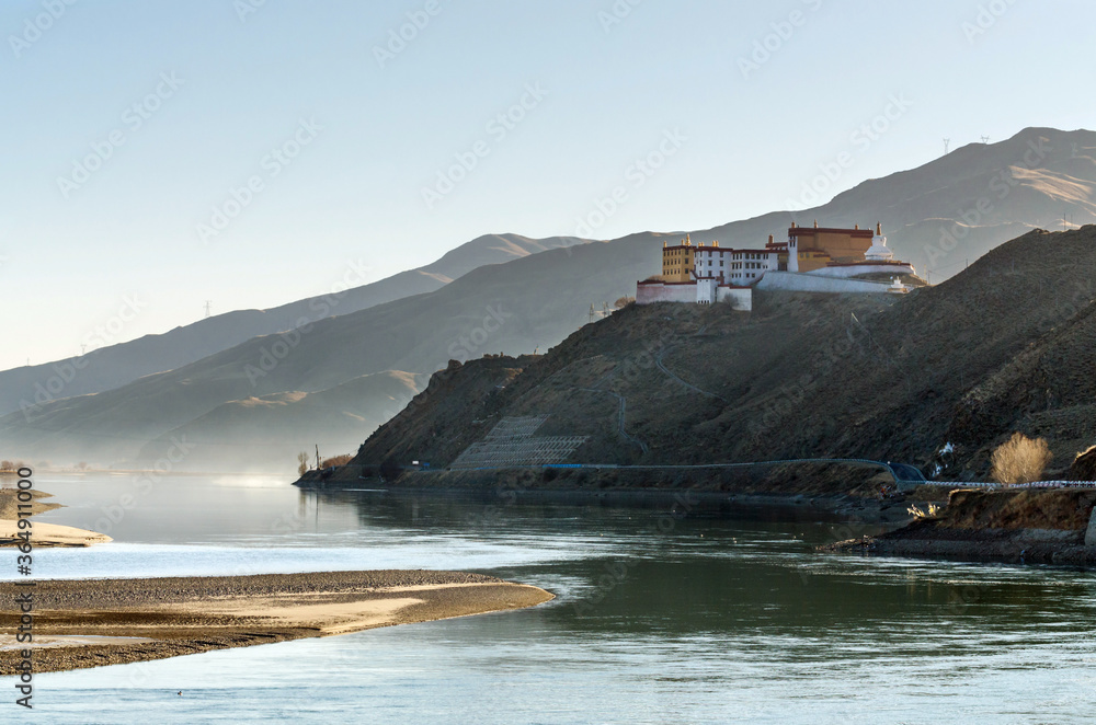 Tibetan Buddhist monastery on a hill near a winding river, Tibet