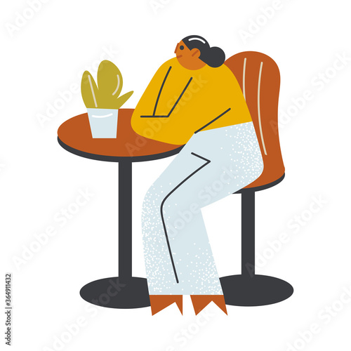 Girl sitting on chair and waiting for order on open veranda of cafe