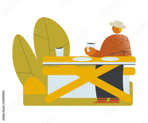Man sitting, having dinner and waiting for his friend on open veranda