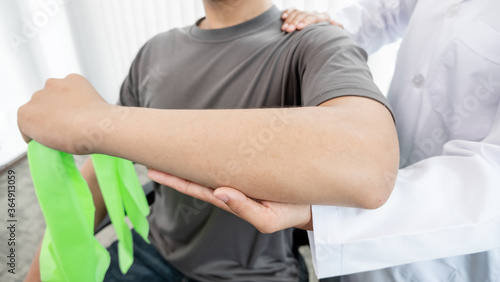 Female physiotherapists provide assistance to male patients with elbow injuries to examine patients in rehabilitation centers. Rehabilitation physiotherapy concept