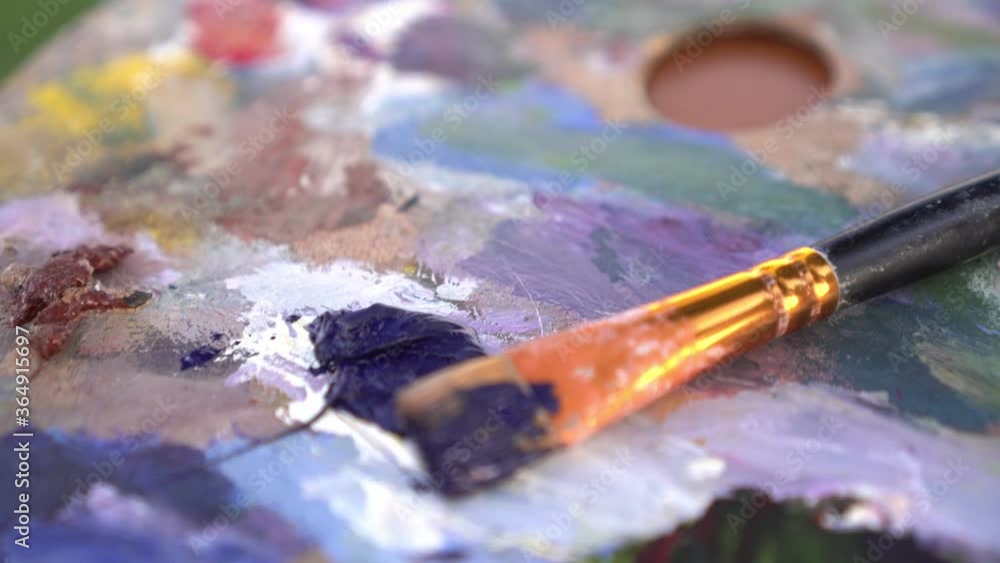 Brush and multicolor bright wooden palette with paints for painting Brush and multicolor bright wooden palette with paints for painting