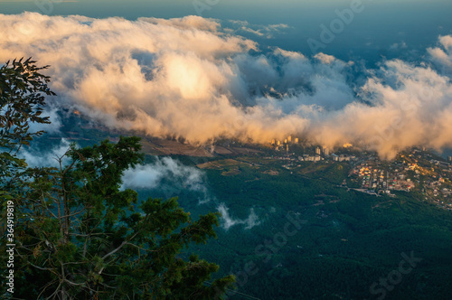 Beautiful landscape of mountains with clouds floating below. Mountain landscape with clouds © oksanamedvedeva