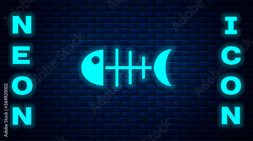 Glowing neon Fish skeleton icon isolated on brick wall background. Fish bone sign. Vector.
