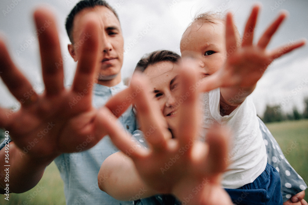 Obraz premium A happy family walks with a child in nature