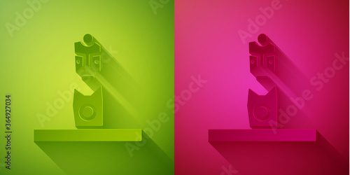 Paper cut Slavic pagan idol icon isolated on green and pink background. Antique ritual wooden idol. Paper art style. Vector.