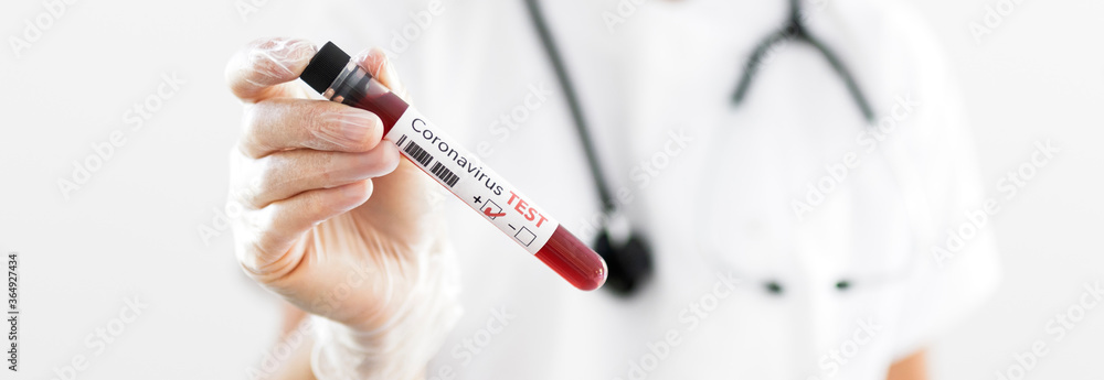 Nurse wearing respirator mask holding a positive blood test Nurse wearing respirator mask holding a positive blood test