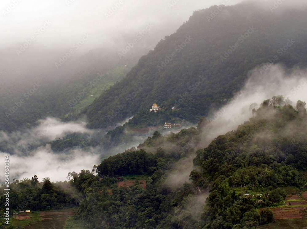 A panoramic view of mist and fog engulfed Ranka village look mesmerizing as seen from Gangtok in East Sikkim. Monsoon gives tremendous different variety of pictorial views to capture. A panoramic view of mist and fog engulfed Ranka village look mesmerizing as seen from Gangtok in East Sikkim. Monsoon gives tremendous different variety of pictorial views to capture.