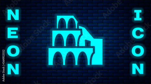 Glowing neon Coliseum in Rome, Italy icon isolated on brick wall background. Colosseum sign. Symbol of Ancient Rome, gladiator fights. Vector.