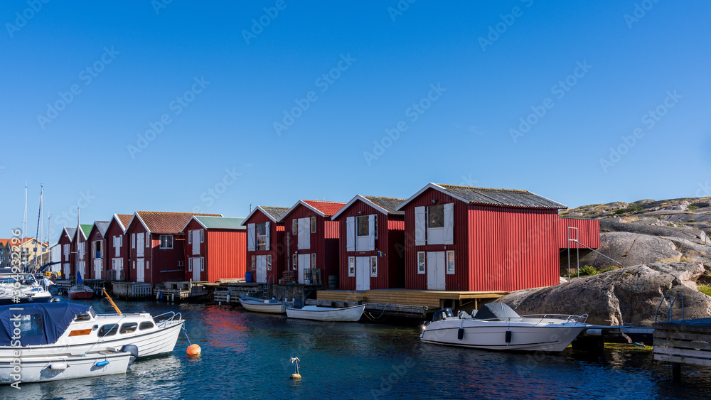 Typical Swedish west coastal environment with red boathouses, bridges and happy summer guests enjoying the perfect weather.
