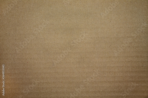 Texture of a cardboard surface in brown.