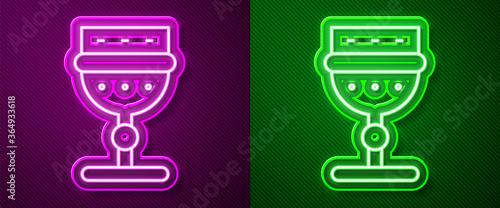 Glowing neon line Medieval goblet icon isolated on purple and green background. Vector.
