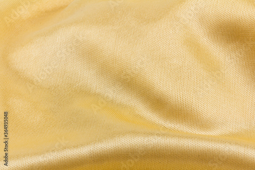 Smooth elegant golden silk or satin luxury cloth texture can use as wedding background. Luxurious background design. Retro style