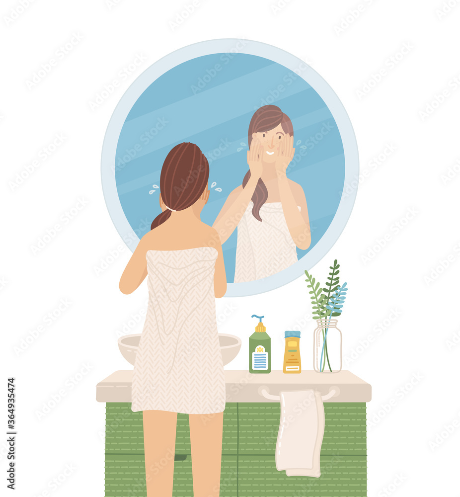 Young woman wearing towel looking at the mirror in bathroom Young woman wearing towel looking at the mirror in bathroom