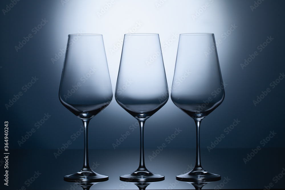 Empty wine glasses on a blue clean gradient background.