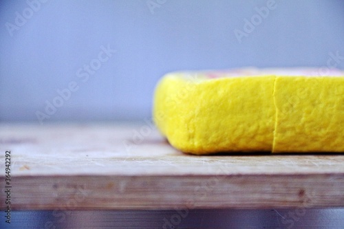 Cut yellow tofu on the wooden butcher 