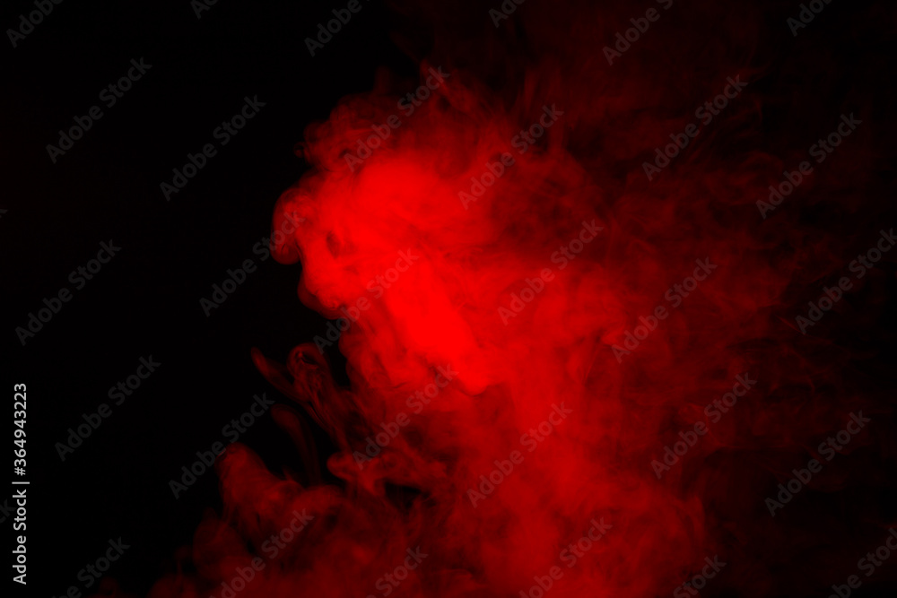 Colorful smoke close-up on a black background. Red cloud of smoke.