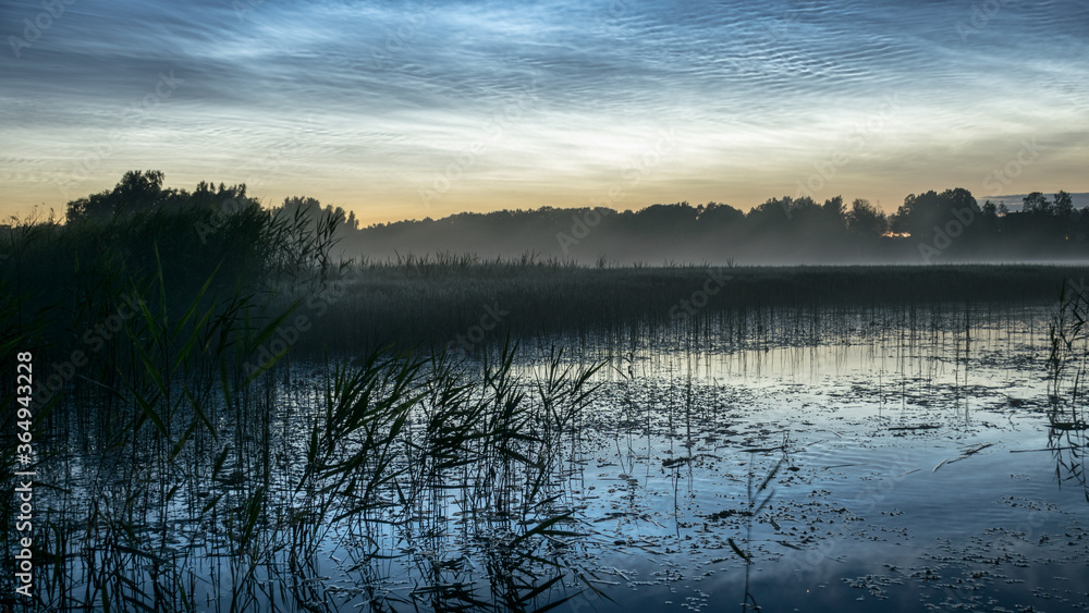 night landscape with white silver clouds over the lake, blurred foreground, charming cloud reflections in the lake water, summer night night landscape with white silver clouds over the lake, blurred foreground, charming cloud reflections in the lake water, summer night