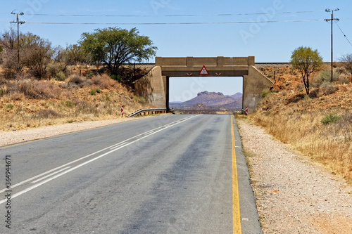 View of a railway bridge, overpass, over the B1-road frames a mountain scene south of Windhoek, the capital city of Namibia photo