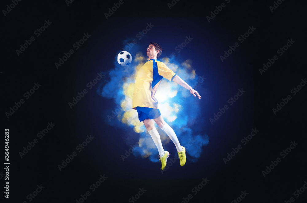Soccer player jumping with ball in smoke Soccer player jumping with ball in smoke