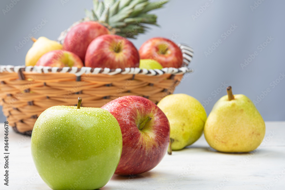 fruits in an arrangement on a white wooden surface with a white background. selective focus.