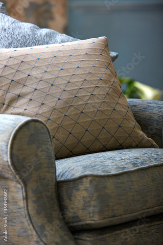 Comfortable armchair with pillow in living room