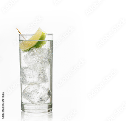 Glass of gin and tonic with ice and lime