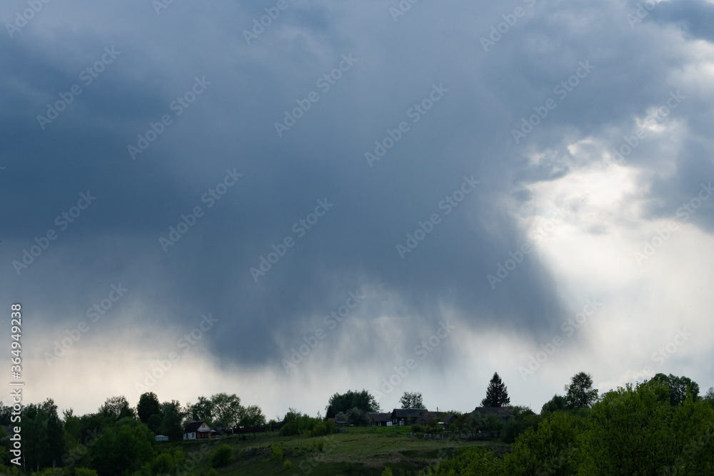 Storm clouds above a mountain village Storm clouds above a mountain village